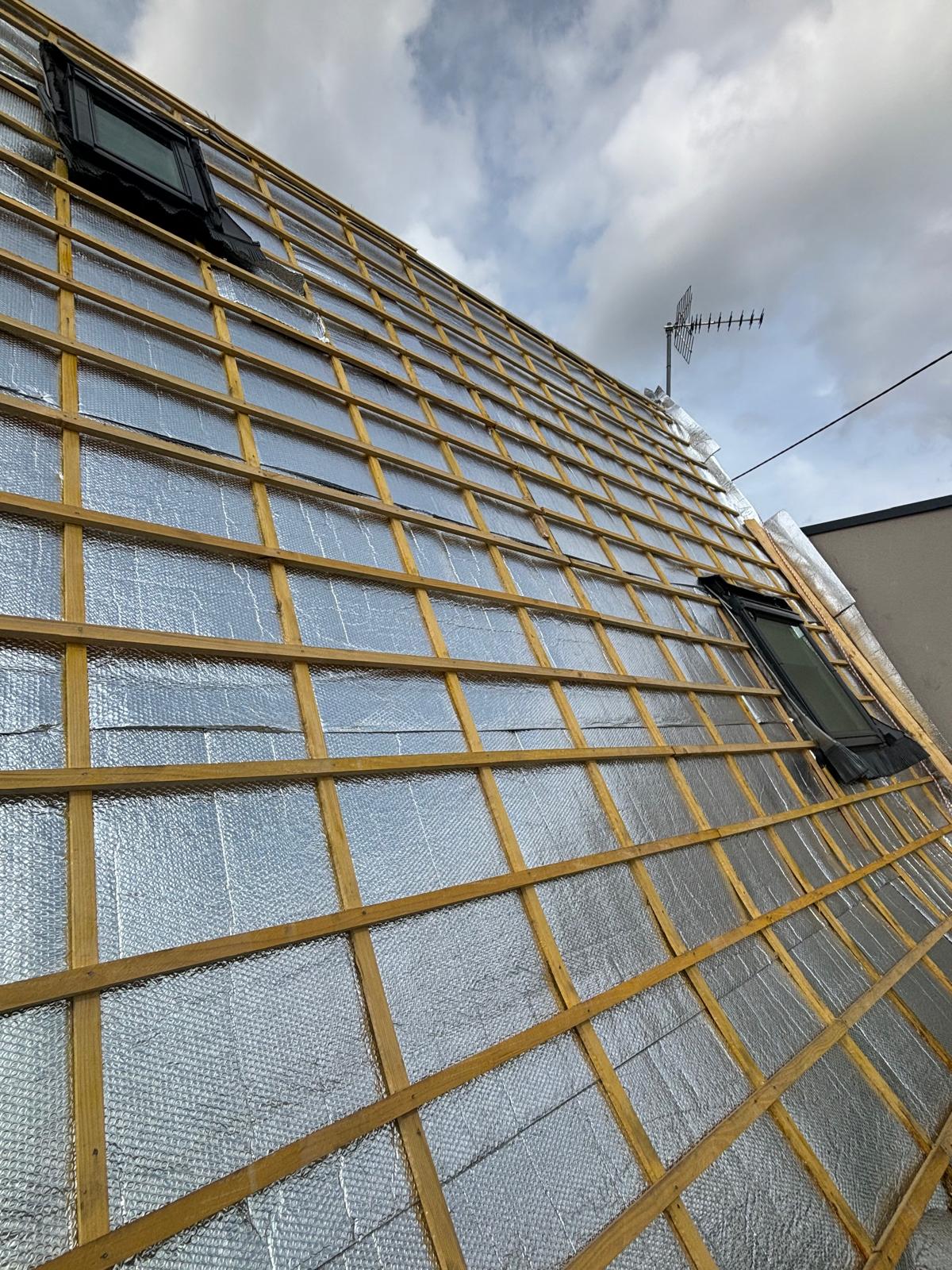 Vue intérieure de combles aménagés éclairés par une fenêtre de toit à Metz
